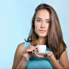 Fototapeta premium Amazing woman holding cup of coffee. Perfect female beauty.