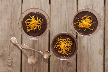 chocolate mousse with orange chips on a dark background