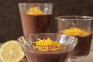 chocolate mousse with orange chips on a dark background