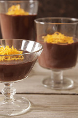 chocolate mousse with orange chips on a dark background