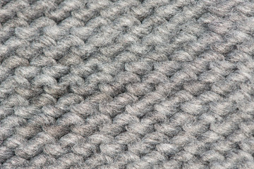 Grey wool knitted background: the purl stitch