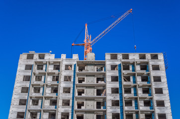 Fototapeta premium Construction of highrise houses and hoisting tower cranes