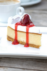 A slice of cheesecake with strawberry sauce