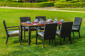 Rattan garden table and chairs  with water resistant outdoor cushions