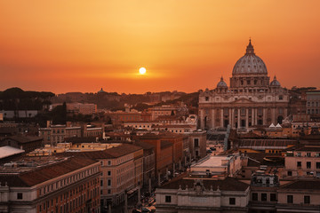 Fototapeta na wymiar Beautiful sunset over Rome, Italy; St. Peter's Basilica on background.