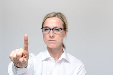 Businesswoman pressing a virtual button