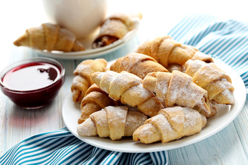 Fresh homemade croissants on a blue wooden table