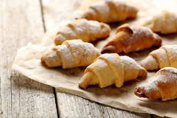 Fresh homemade croissants on a grey wooden table