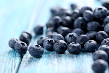 Tasty blueberries on a blue wooden table