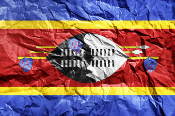 Swaziland flag painted on crumpled paper background