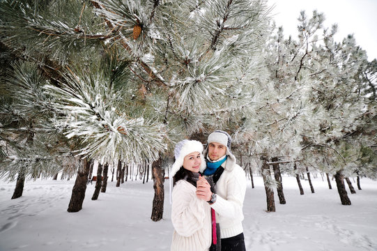 couple on the background of snowy trees