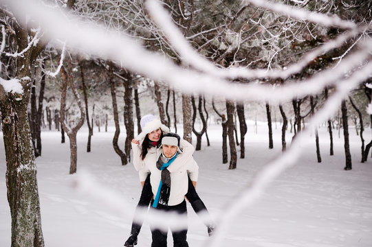 couple on the background of snowy trees