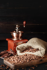 Fototapeta na wymiar Still life of coffee beans in jute bags with coffee grinder