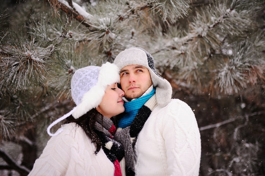 couple on the background of snowy trees
