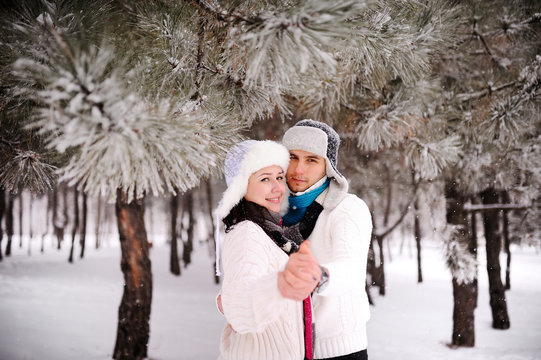 couple on the background of snowy trees