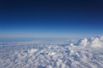 Fototapeta na wymiar View on the blue sky from the airplane