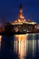Night view of the oil rig standing during the renovation in Gdansk Repair Shipyard
