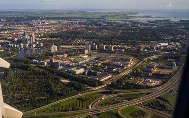 Fototapeta na wymiar Amsterdam European Capital City and water harbour Aerial View from Jet Aircraft Porthole (North Holland, The Netherlands)