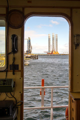 Oil rig  A view through the door of the wheelhouse of the vessel on the drilling platform © pryc1969