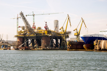 Fototapeta na wymiar View of a serviced drilling platform in Gdansk Shiprepair Yard side of the port channel