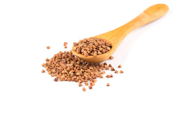 Uncooked buckwheat on wooden spoon