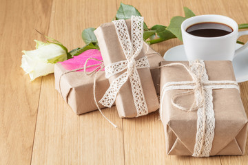 Paper wrapped gift box with white rose