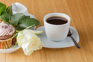 cup of black coffee and rose on desktop