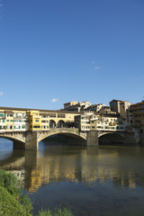 Naklejka premium Ponte Vecchio in Florence Italy with skyline reflection on the Arno River