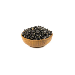 Seed black beans in wood cup isolated on white