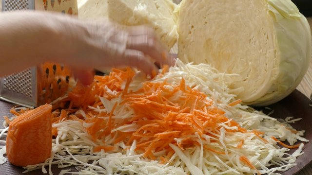 mixing of chopped cabbage and grated carrot