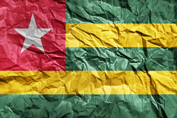 Togo flag painted on crumpled paper background