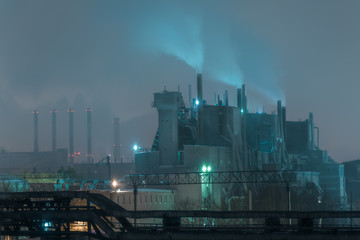Part of big oil refinery in a foggy full moon night