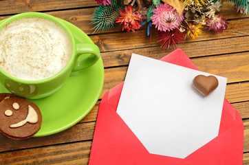Obraz na płótnie Canvas Red envelope with empty paper and cappuccino cup