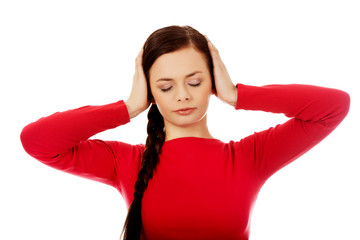 Young woman with headache holding her hand to the head