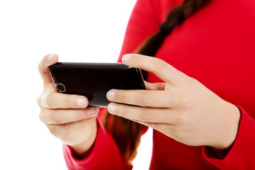 Young woman writing sms on smartphone