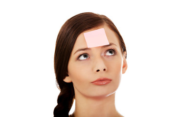 Young woman with sticky notes on forehead