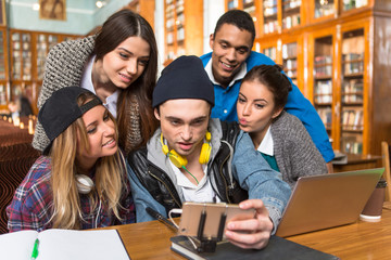 Students making selfies in library