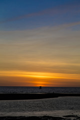 Sun setting down the horizon on an orange beach African sunset 