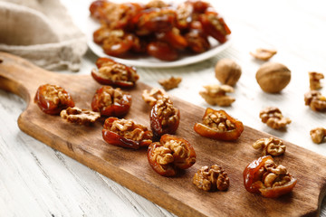 Walnut in date fruit on cutting board, close-up