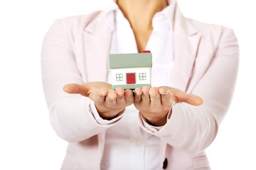 Business woman holding a house model