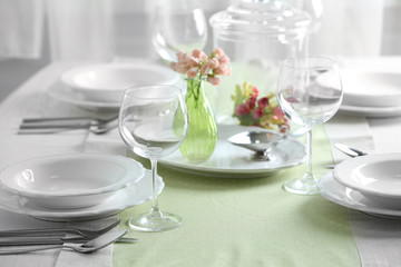 Table set at restaurant on light background