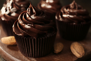 Chocolate cupcakes with nuts on cutting board