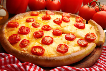 Pizza Margherita, removed slice and vegetables, close-up