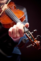 Fototapeta premium Violinist's performance on black background, close up