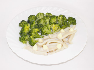 Cooked broccoli with squid in a white plate
