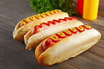 Tasty hotdogs on wooden background