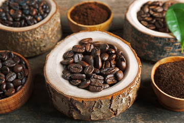 Different coffee beans on wooden table, close up