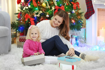 Fototapeta na wymiar Mother with daughter near Christmas tree