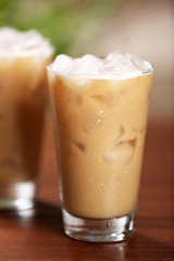 Cups of ice coffee on wooden table