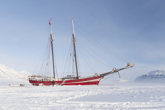 Sailboat stranded on sea ice - Horizontal